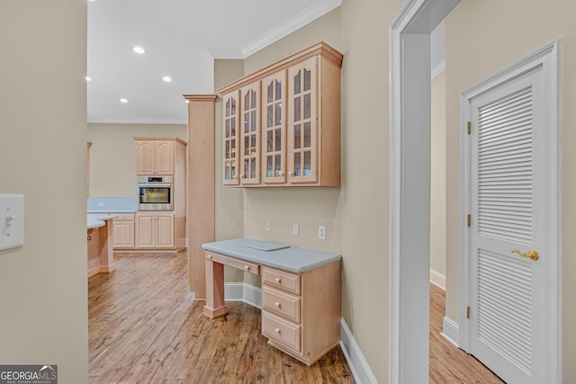 office featuring ornamental molding and light wood-type flooring