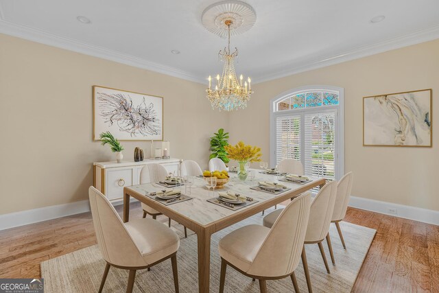 dining area with a notable chandelier, ornamental molding, and light wood-type flooring