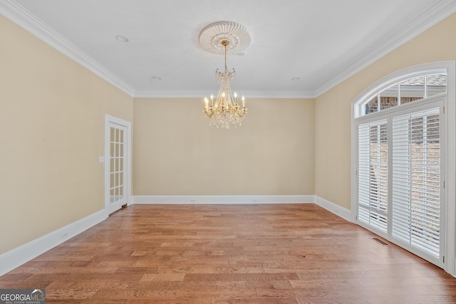 unfurnished dining area with ornamental molding, light hardwood / wood-style floors, and a chandelier