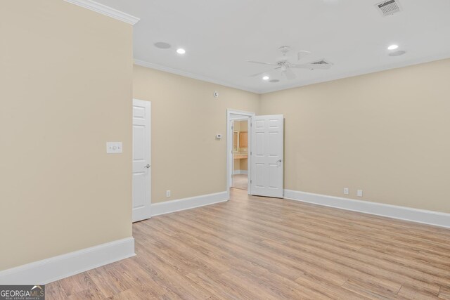 empty room with crown molding, ceiling fan, and light hardwood / wood-style floors