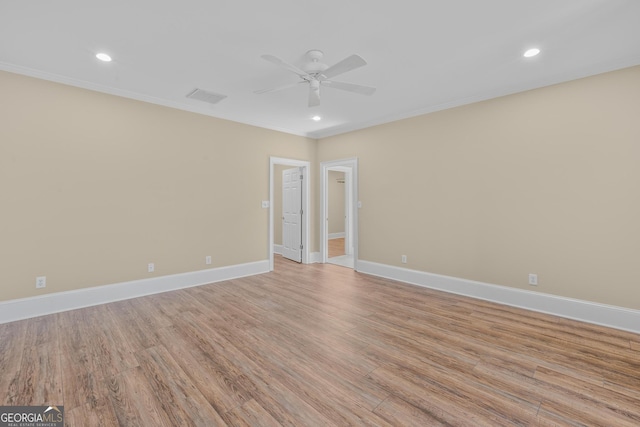 unfurnished room featuring crown molding, ceiling fan, and light hardwood / wood-style flooring