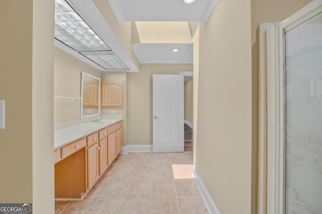 bathroom featuring vanity, ornamental molding, tile patterned floors, and a shower