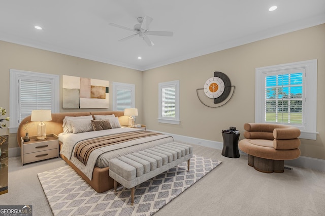 bedroom with ornamental molding, light colored carpet, and ceiling fan