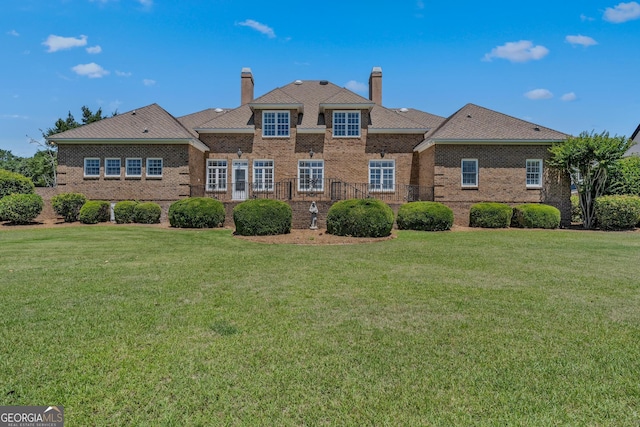 rear view of property featuring a yard