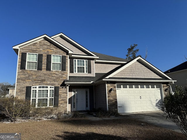 view of front facade with a garage, stone siding, and driveway