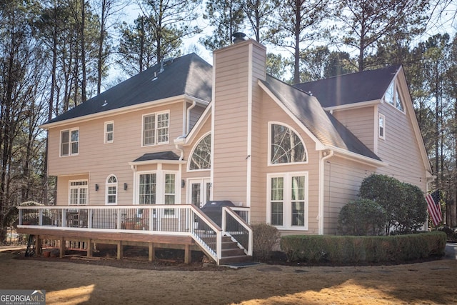 rear view of house featuring a deck