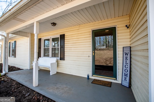 view of exterior entry with covered porch