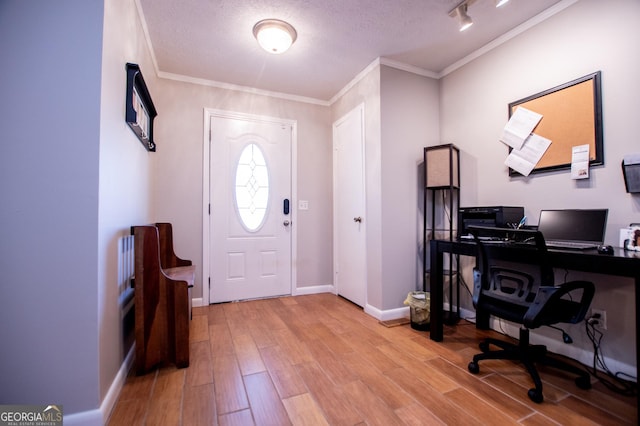 home office featuring crown molding, a textured ceiling, and light hardwood / wood-style floors