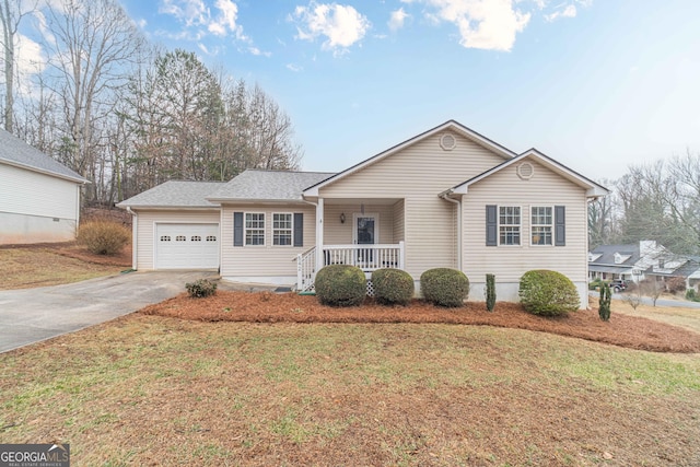 ranch-style house with a porch, a garage, and a front yard