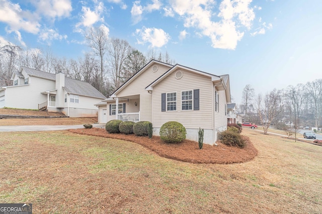 view of home's exterior featuring a porch and a yard