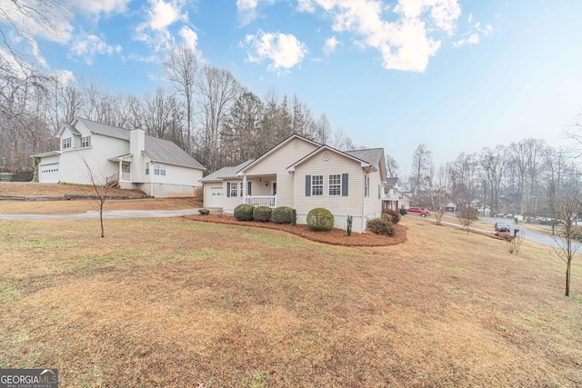 view of side of home featuring a yard and covered porch