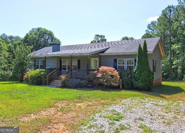 single story home with a front yard and covered porch