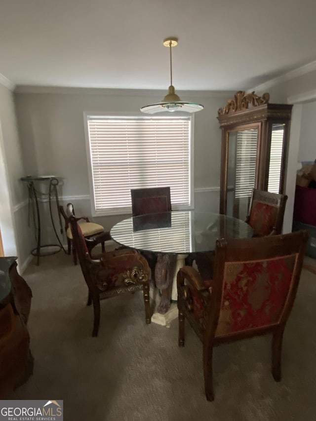 dining room featuring crown molding and carpet flooring