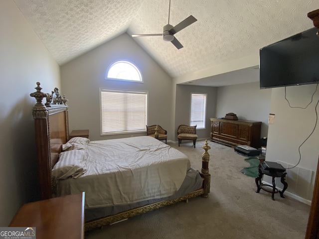 bedroom with ceiling fan, carpet flooring, vaulted ceiling, and a textured ceiling