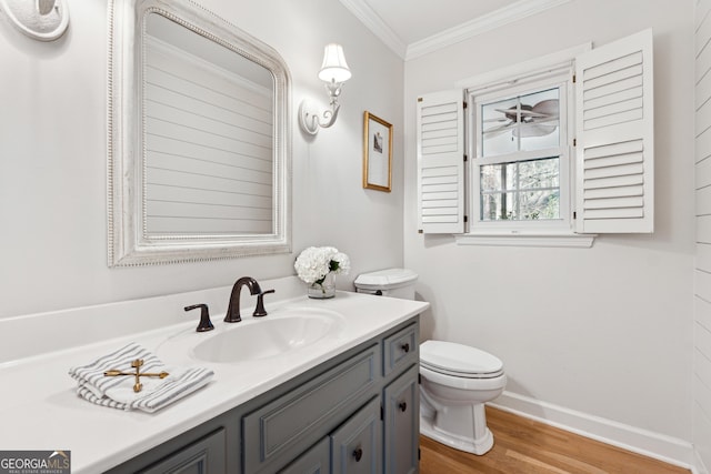 bathroom featuring ornamental molding, hardwood / wood-style floors, vanity, and toilet