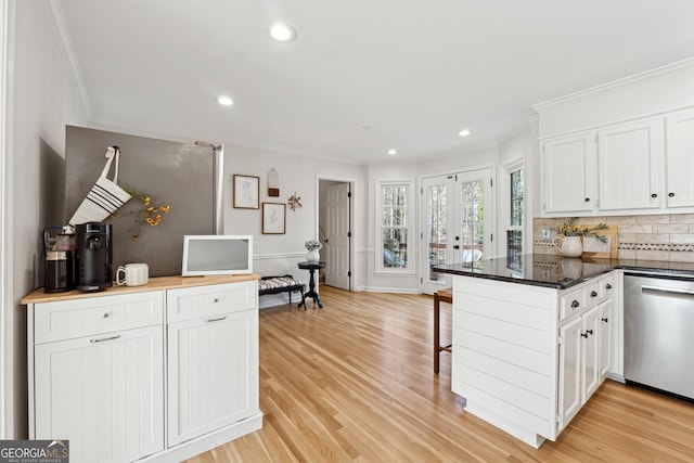 kitchen with white cabinetry, stainless steel dishwasher, light hardwood / wood-style floors, and kitchen peninsula