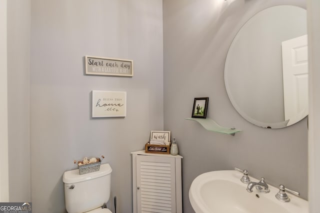 bathroom featuring sink and toilet