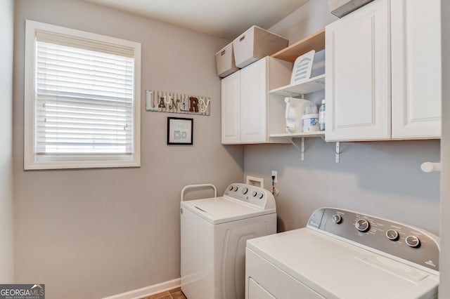 laundry area with washing machine and dryer and cabinets