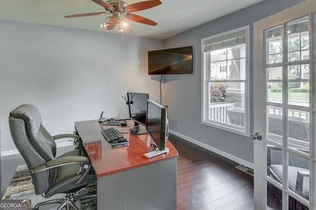 home office with dark hardwood / wood-style floors and ceiling fan