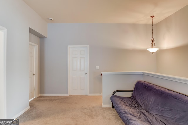 sitting room featuring light carpet