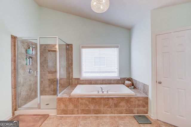 bathroom with plus walk in shower, lofted ceiling, and tile patterned floors