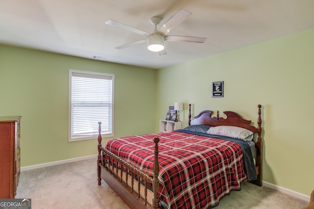 bedroom with light colored carpet and ceiling fan