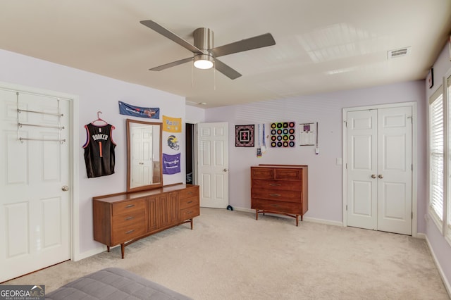 bedroom with ceiling fan and light carpet