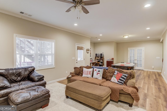 living room featuring ornamental molding, ceiling fan, light hardwood / wood-style floors, and french doors