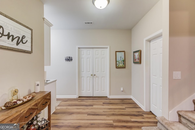 hallway with light hardwood / wood-style floors