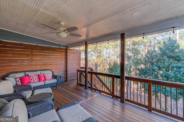 wooden terrace with ceiling fan and an outdoor hangout area