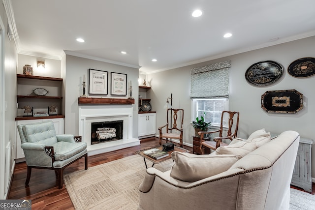 living room with wood-type flooring and ornamental molding