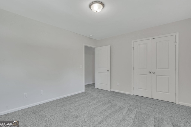 unfurnished bedroom featuring carpet flooring and a closet