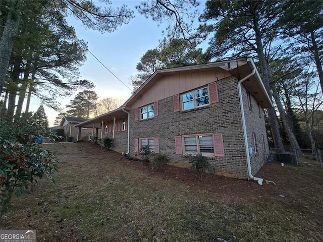 property exterior at dusk with a yard