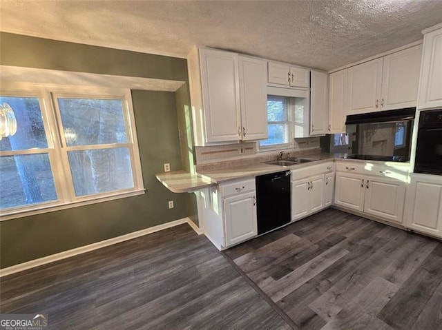 kitchen featuring white cabinetry, dark hardwood / wood-style flooring, black appliances, and a textured ceiling