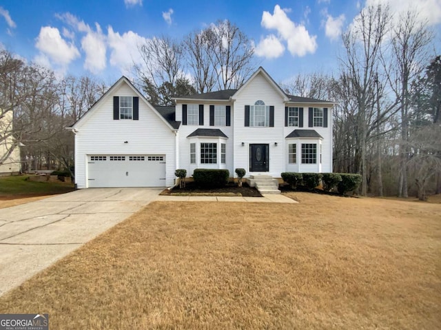 view of front of home featuring a garage and a front lawn