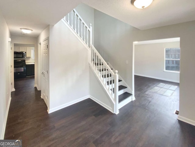 staircase with hardwood / wood-style floors