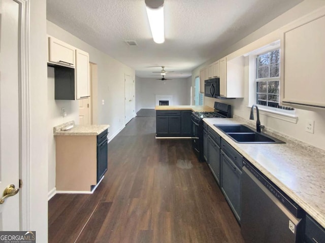 kitchen with sink, ceiling fan, dark hardwood / wood-style floors, black appliances, and white cabinets