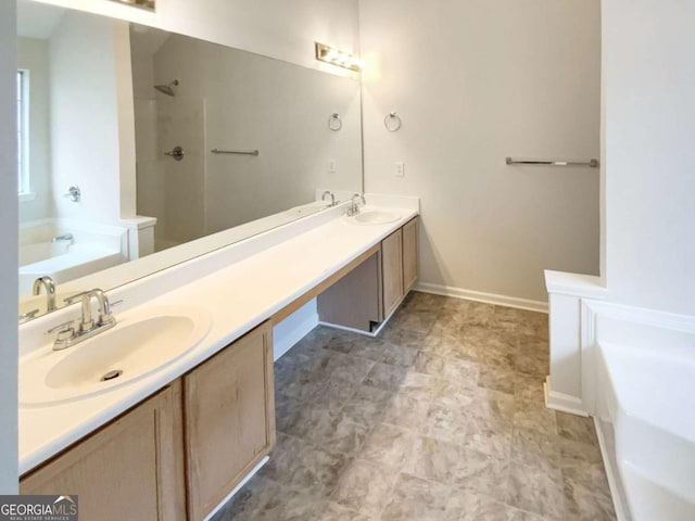 bathroom with vanity and shower with separate bathtub