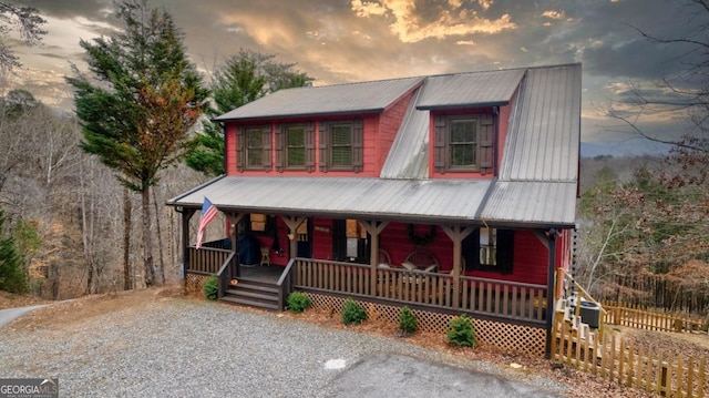 view of front of property featuring cooling unit and covered porch