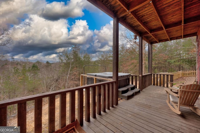 wooden terrace with a hot tub