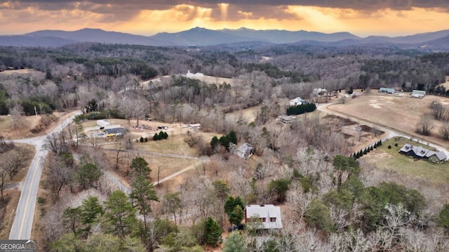 aerial view at dusk featuring a mountain view