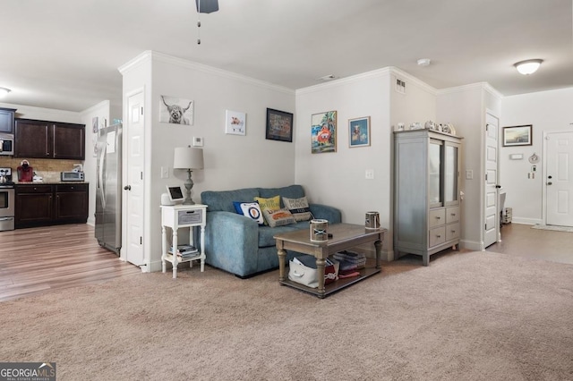 living room featuring crown molding and light colored carpet