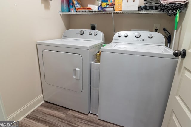 washroom featuring wood-type flooring and washer and clothes dryer