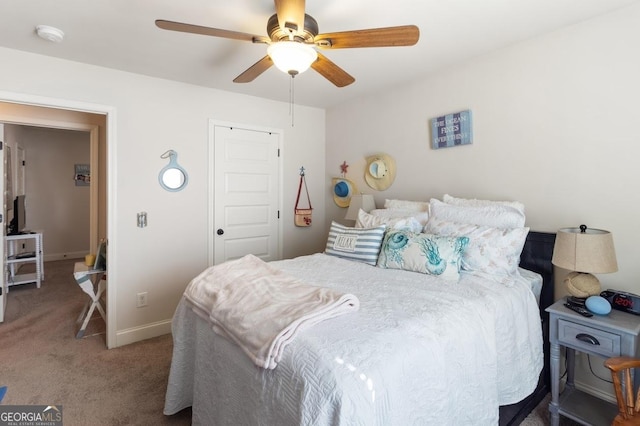 carpeted bedroom featuring ceiling fan and a closet