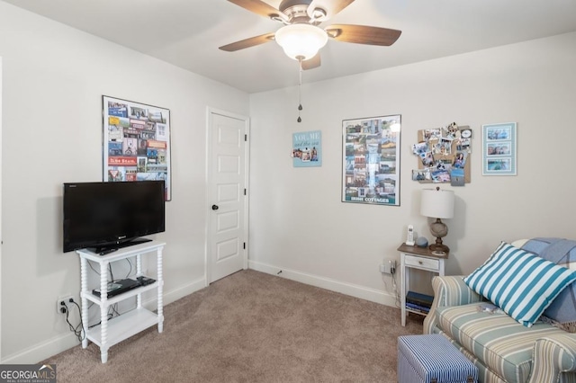 living area featuring light colored carpet and ceiling fan