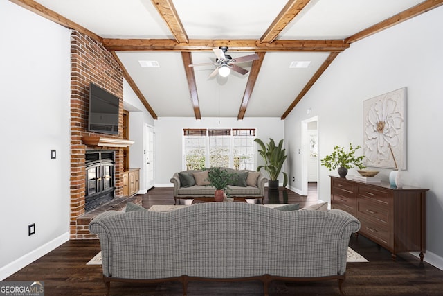 living room with ceiling fan, a brick fireplace, vaulted ceiling with beams, and dark hardwood / wood-style floors