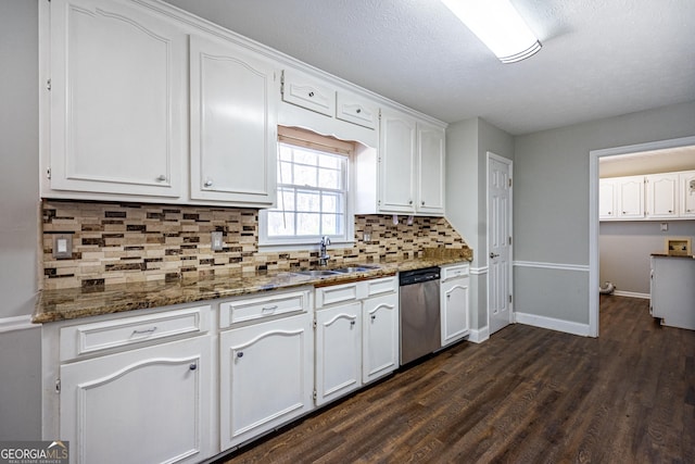 kitchen featuring sink, white cabinetry, dark stone countertops, dark hardwood / wood-style flooring, and dishwasher