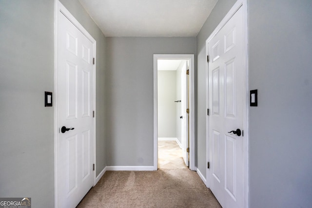 hallway featuring light carpet