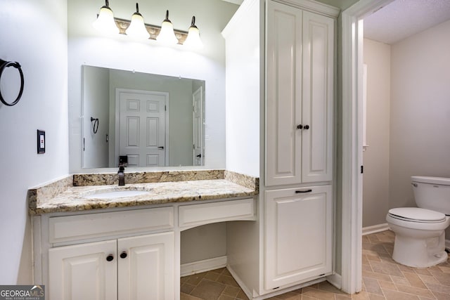 bathroom with vanity and toilet