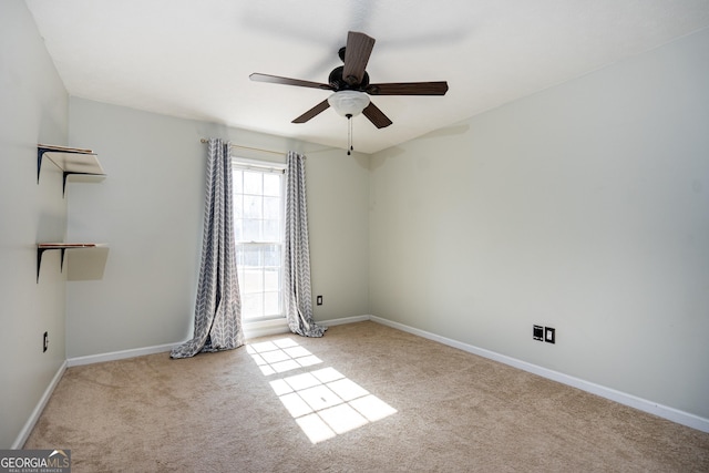 empty room featuring light colored carpet and ceiling fan